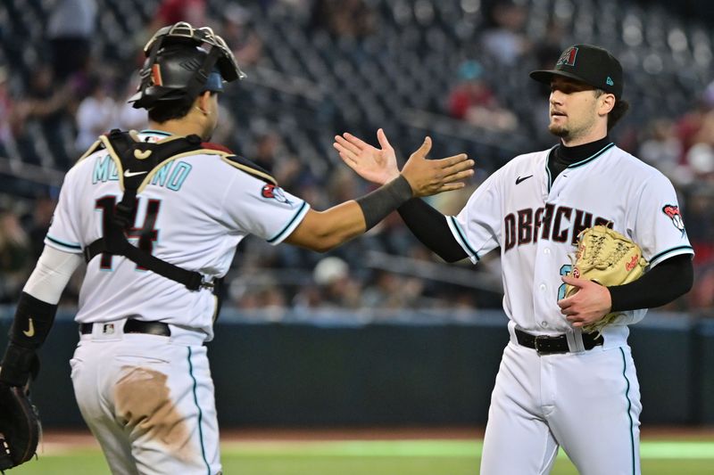 Sep 20, 2023; Phoenix, Arizona, USA;  Arizona Diamondbacks relief pitcher Kyle Nelson (24) celebrates with catcher Gabriel Moreno (14) after defeating the San Francisco Giants 7-1 at Chase Field. Mandatory Credit: Matt Kartozian-USA TODAY Sports