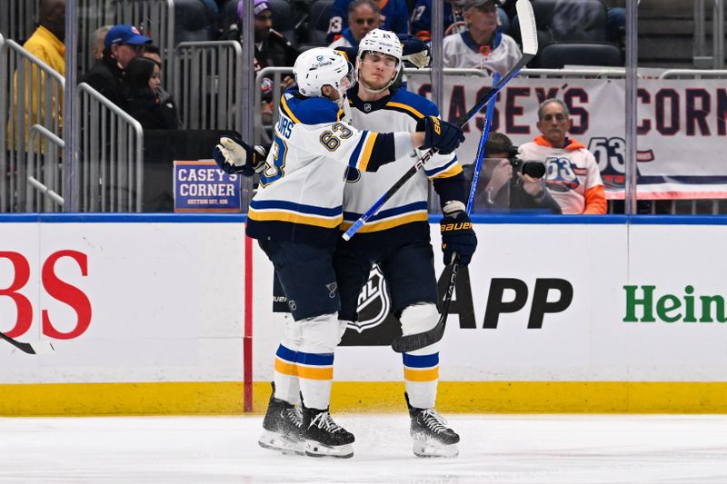 Mar 5, 2024; Elmont, New York, USA;  St. Louis Blues right wing Alexey Toropchenko (13) celebrates his goal against the New York Islanders with St. Louis Blues left wing Jake Neighbours (63) during the second period at UBS Arena. Mandatory Credit: Dennis Schneidler-USA TODAY Sports