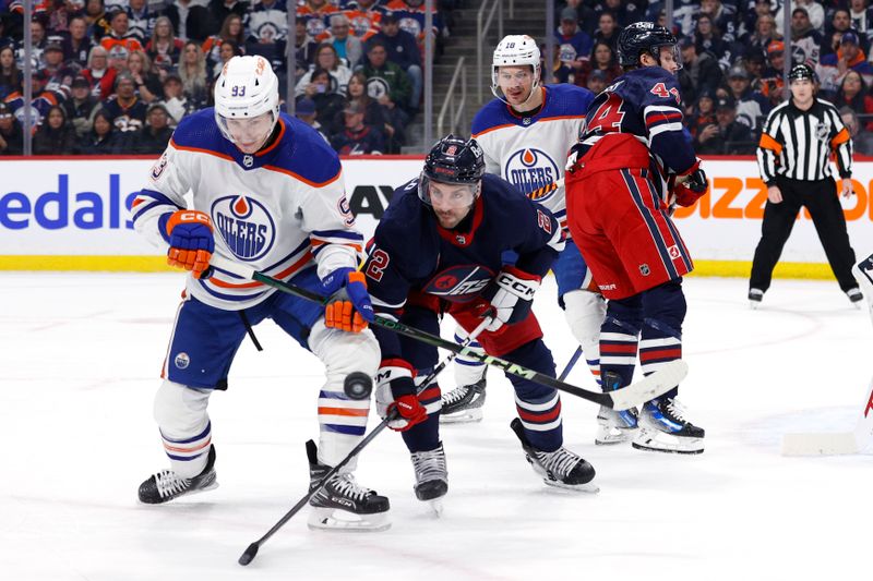 Mar 26, 2024; Winnipeg, Manitoba, CAN; Edmonton Oilers center Ryan Nugent-Hopkins (93) and Winnipeg Jets defenseman Dylan DeMelo (2) scramble for the puck in the first period at Canada Life Centre. Mandatory Credit: James Carey Lauder-USA TODAY Sports