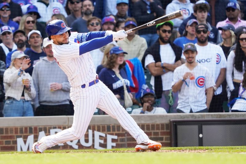 May 6, 2023; Chicago, Illinois, USA; Chicago Cubs third baseman Nick Madrigal (1) hits a two RBI single against the Miami Marlins during the eighth inning at Wrigley Field. Mandatory Credit: David Banks-USA TODAY Sports