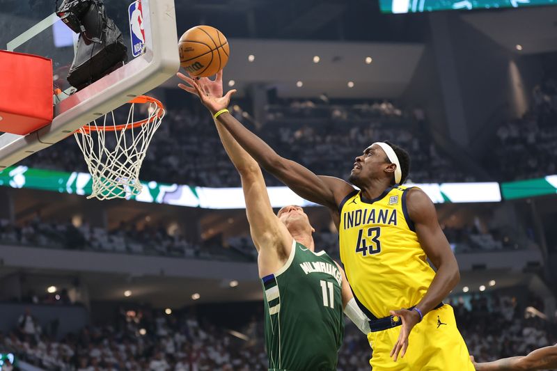 MILWAUKEE, WISCONSIN - APRIL 23: Brook Lopez #11 of the Milwaukee Bucks blocks a shot by Pascal Siakam #43 of the Indiana Pacers during the first half of game two of the Eastern Conference First Round Playoffs at Fiserv Forum on April 23, 2024 in Milwaukee, Wisconsin. NOTE TO USER: User expressly acknowledges and agrees that, by downloading and or using this photograph, User is consenting to the terms and conditions of the Getty Images License Agreement. (Photo by Stacy Revere/Getty Images)