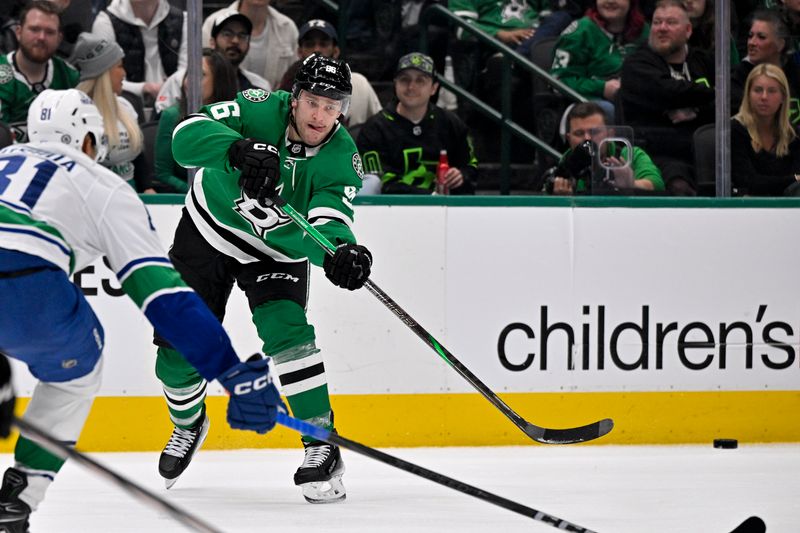 Apr 8, 2025; Dallas, Texas, USA; Dallas Stars right wing Mikko Rantanen (96) passes the puck by Vancouver Canucks center Dakota Joshua (81) during the second period at the American Airlines Center. Mandatory Credit: Jerome Miron-Imagn Images