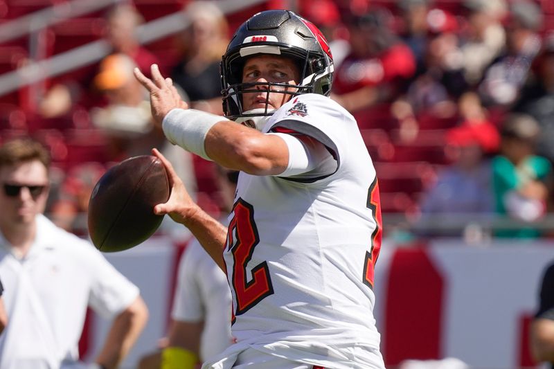 Tampa Bay Buccaneers quarterback Tom Brady (12) warms up before the first half of an NFL football game between the Tampa Bay Buccaneers and the Atlanta Falcons Sunday, Oct. 9, 2022, in Tampa, Fla. (AP Photo/Chris O'Meara)