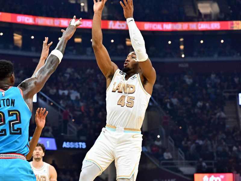 CLEVELAND, OHIO - JANUARY 04: Donovan Mitchell #45 of the Cleveland Cavaliers shoots over Deandre Ayton #22 of the Phoenix Suns during the first half at Rocket Mortgage Fieldhouse on January 04, 2023 in Cleveland, Ohio. NOTE TO USER: User expressly acknowledges and agrees that, by downloading and or using this photograph, User is consenting to the terms and conditions of the Getty Images License Agreement. (Photo by Jason Miller/Getty Images)