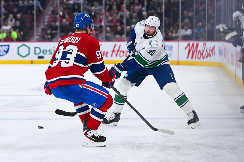 Jan 12, 2026; Montreal, Quebec, CAN; Vancouver Canucks defenseman Marcus Pettersson (29) plays the puck against Montreal Canadiens right wing Ivan Demidov (93) during the third period at Bell Centre. Mandatory Credit: David Kirouac-Imagn Images