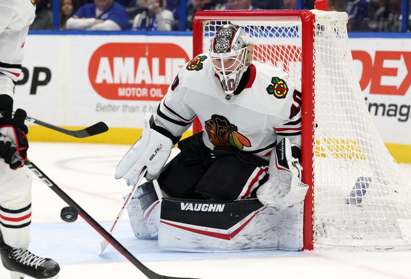 Jan 28, 2025; Tampa, Florida, USA; Chicago Blackhawks goaltender Arvid Soderblom (40) defends the puck against the Tampa Bay Lightning during the third period at Amalie Arena. Mandatory Credit: Kim Klement Neitzel-Imagn Images