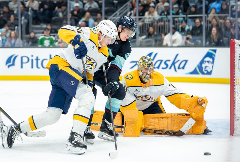 Mar 10, 2026; Seattle, Washington, USA; Nashville Predators defenseman Brady Skjei (76), left, and goalie Juuse Saros (74), right, battle with Seattle Kraken forward Kaapo Kakko (84) for puck during the second period at Climate Pledge Arena. Mandatory Credit: Stephen Brashear-Imagn Images