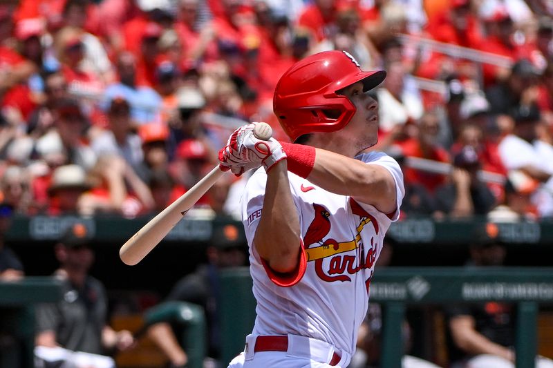 Jun 14, 2023; St. Louis, Missouri, USA;  St. Louis Cardinals center fielder Tommy Edman (19) hits a grand slam against the San Francisco Giants during the second inning at Busch Stadium. Mandatory Credit: Jeff Curry-USA TODAY Sports