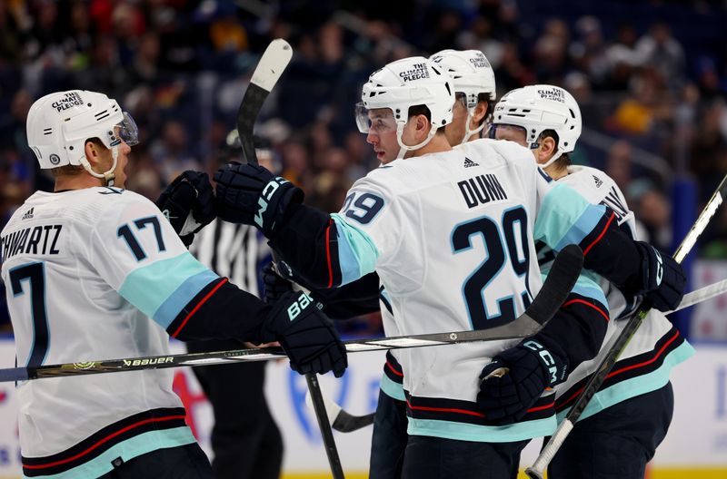 Jan 9, 2024; Buffalo, New York, USA;  Seattle Kraken defenseman Vince Dunn (29) celebrates his goal with teammates during the first period against the Buffalo Sabres at KeyBank Center. Mandatory Credit: Timothy T. Ludwig-USA TODAY Sports