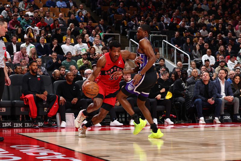 TORONTO, CANADA - MARCH 20: Ochai Agbaji #30 of the Toronto Raptors drives to the basket during the game against the Sacramento Kings on March 20, 2024 at the Scotiabank Arena in Toronto, Ontario, Canada.  NOTE TO USER: User expressly acknowledges and agrees that, by downloading and or using this Photograph, user is consenting to the terms and conditions of the Getty Images License Agreement.  Mandatory Copyright Notice: Copyright 2024 NBAE (Photo by Vaughn Ridley/NBAE via Getty Images)