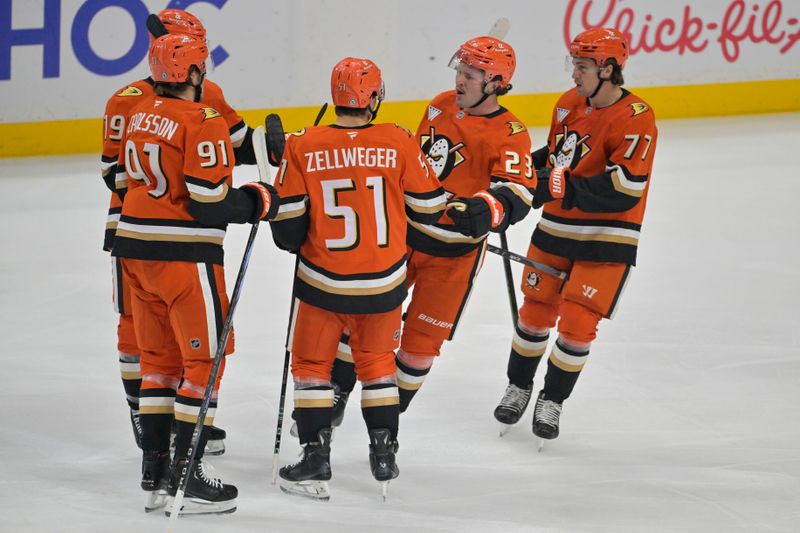 Nov 5, 2024; Anaheim, California, USA; Anaheim Ducks defenseman Olen Zellweger (51) is congratulated after scoring a goal in the first period against the Vancouver Canucks at Honda Center. Mandatory Credit: Jayne Kamin-Oncea-Imagn Images