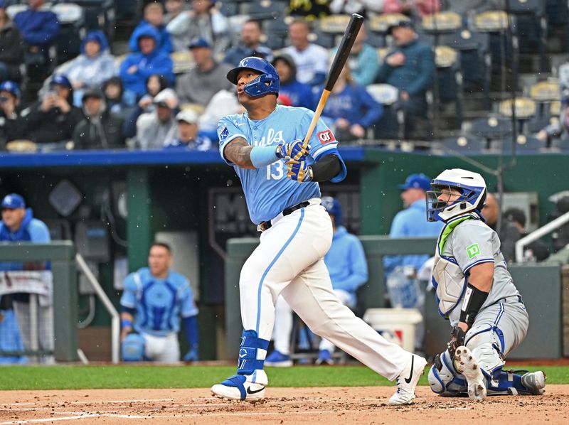 Apr 25, 2024; Kansas City, Missouri, USA;  Kansas City Royals first baseman Salvador Perez (13) hits a two run home run in the first inning against the Toronto Blue Jays at Kauffman Stadium. Mandatory Credit: Peter Aiken-USA TODAY Sports