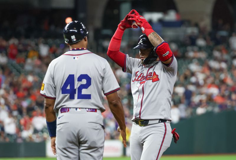 Apr 15, 2024; Houston, Texas, USA; Atlanta Braves pitch hitter Orlando Arcia (11) hits a RBI single against the Houston Astros in the ninth inning at Minute Maid Park. All players wore #42 in honor of Jackie Robinson Day. Mandatory Credit: Thomas Shea-USA TODAY Sports