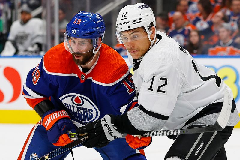 May 1, 2024; Edmonton, Alberta, CAN; Edmonton Oilers forward Adam Henrique (19) and Los Angeles Kings forward Trevor Moore (12) battle for a loose puck during the first period in game five of the first round of the 2024 Stanley Cup Playoffs at Rogers Place. Mandatory Credit: Perry Nelson-USA TODAY Sports