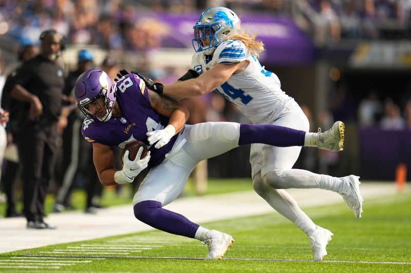 Detroit Lions linebacker Alex Anzalone (34) tackles Minnesota Vikings tight end Josh Oliver (84) during the second half of an NFL football game Sunday, Oct. 20, 2024, in Minneapolis. (AP Photo/Abbie Parr)