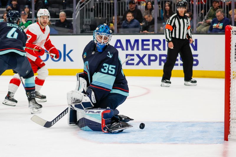 Feb 19, 2024; Seattle, Washington, USA; Seattle Kraken goaltender Joey Daccord (35) watches the puck go into the net for a goal by the Detroit Red Wings during the first period at Climate Pledge Arena. Mandatory Credit: Joe Nicholson-USA TODAY Sports