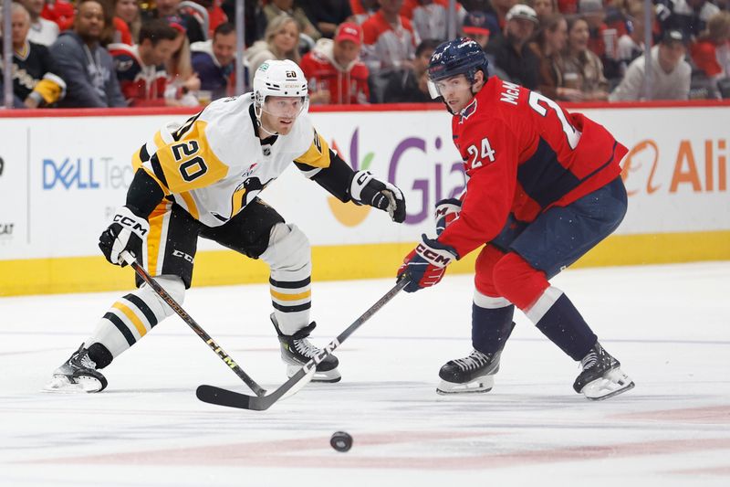 Nov 8, 2024; Washington, District of Columbia, USA; Pittsburgh Penguins center Lars Eller (20) and Washington Capitals center Connor McMichael (24) battle for the puck in the third period at Capital One Arena. Mandatory Credit: Geoff Burke-Imagn Images