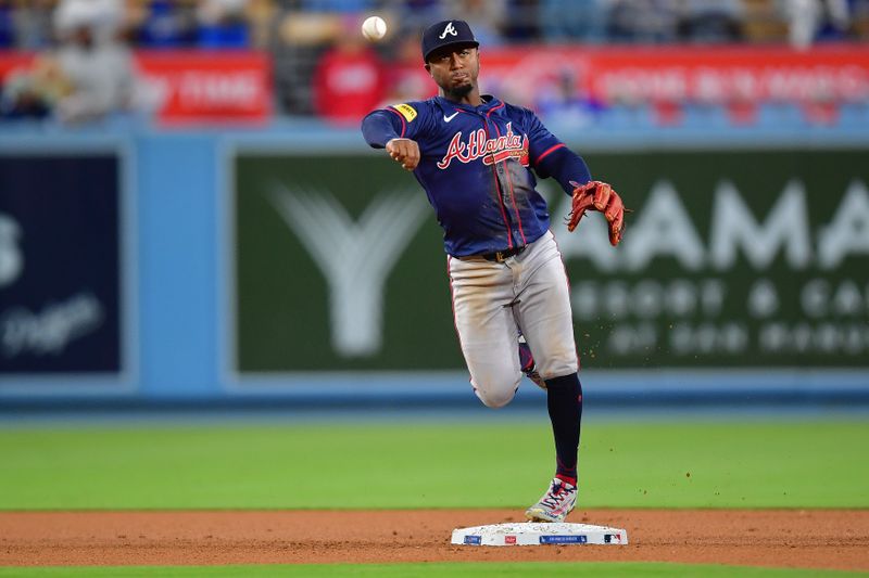 May 4, 2024; Los Angeles, California, USA; Atlanta Braves second baseman Ozzie Albies (1) throws to first for the out against Los Angeles Dodgers right fielder Andy Pages (84) during the eighth inning at Dodger Stadium. Mandatory Credit: Gary A. Vasquez-USA TODAY Sports