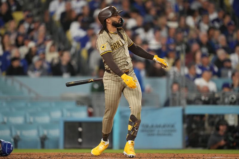 Sep 25, 2024; Los Angeles, California, USA;  San Diego Padres right fielder Fernando Tatis Jr. (23) hits a home run in the fifth inning against the Los Angeles Dodgers at Dodger Stadium. Mandatory Credit: Kirby Lee-Imagn Images