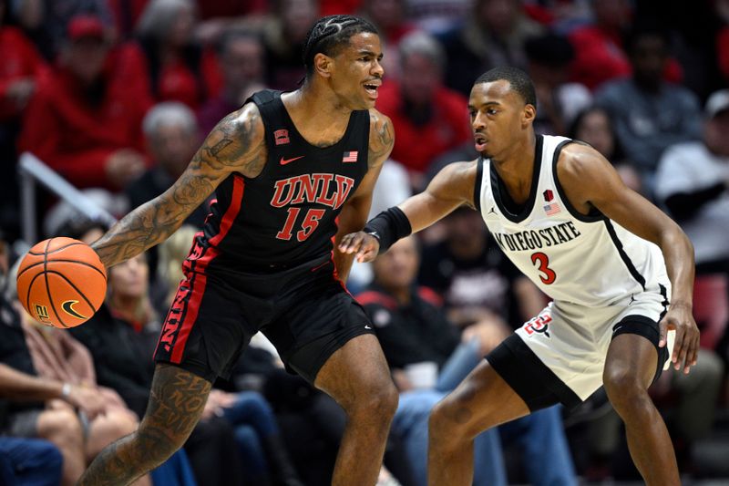 Jan 6, 2024; San Diego, California, USA; UNLV Rebels guard Luis Rodriguez (15) dribbles the ball while defended by San Diego State Aztecs guard Micah Parrish (3) during the first half at Viejas Arena. Mandatory Credit: Orlando Ramirez-USA TODAY Sports