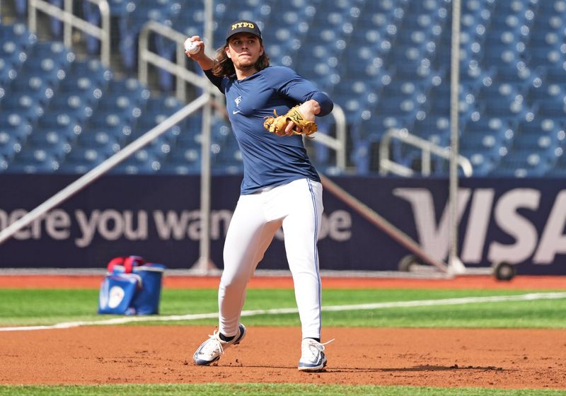 Sep 11, 2024; Toronto, Ontario, CAN; Toronto Blue Jays outfielder Addison Barger (47) throws a ball to first base during batting practice wearing a City of New York Fire Department baseball cap before a game against the New York Mets at Rogers Centre. Mandatory Credit: Nick Turchiaro-Imagn Images