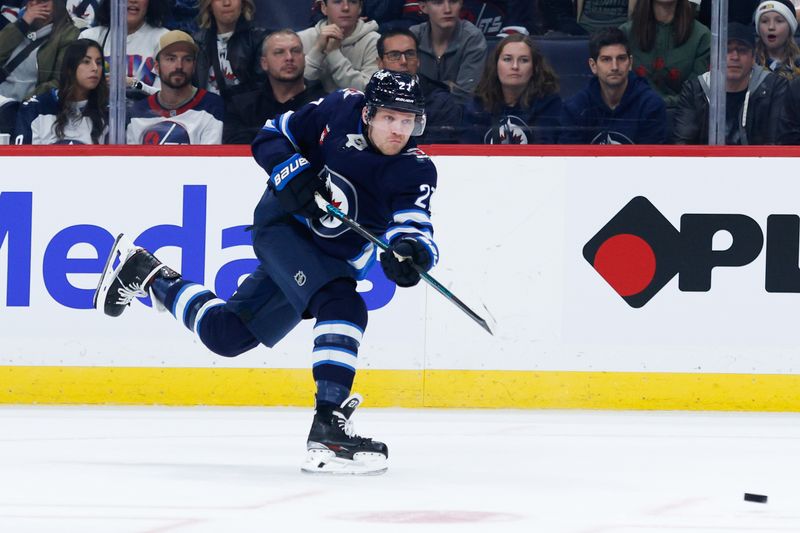 Nov 5, 2024; Winnipeg, Manitoba, CAN;  Winnipeg Jets forward Nikolaj Ehlers (27) takes a shot on the Utah Hockey Club net during the second period at Canada Life Centre. Mandatory Credit: Terrence Lee-Imagn Images