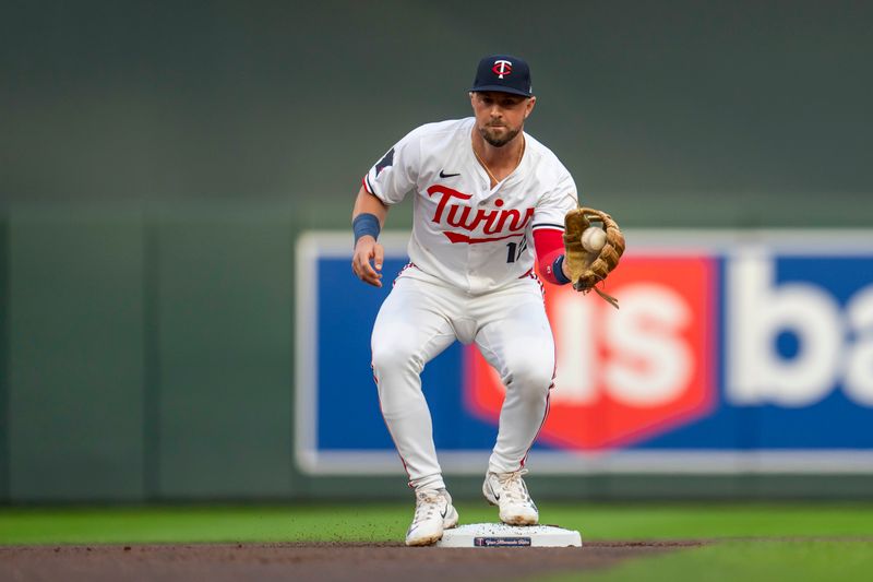 Sep 9, 2024; Minneapolis, Minnesota, USA; Minnesota Twins second baseman Kyle Farmer (12) catches a throw from shortstop Brooks Lee (not pictured) to set up a double play against the Los Angeles Angels in the first inning at Target Field. Mandatory Credit: Jesse Johnson-Imagn Images