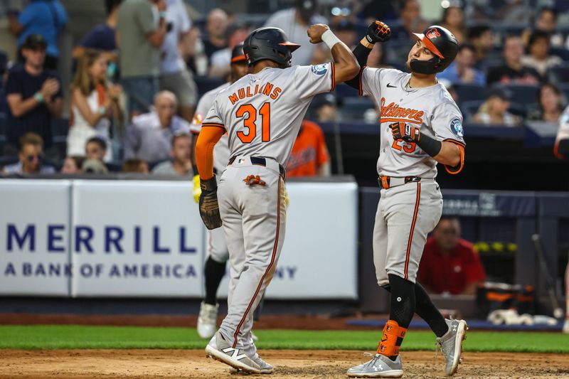 Jun 19, 2024; Bronx, New York, USA;  Baltimore Orioles third baseman Ramón Urías (29) is greeted by center fielder Cedric Mullins (31) after hitting a two-run home run in the fifth inning against the New York Yankees at Yankee Stadium. Mandatory Credit: Wendell Cruz-USA TODAY Sports