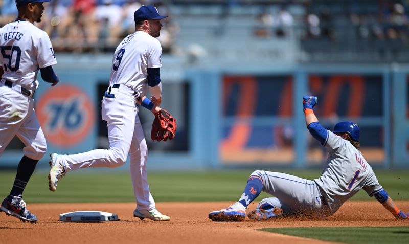 Apr 21, 2024; Los Angeles, California, USA; Los Angeles Dodgers second baseman Gavin Lux (9) with shortstop Mookie Betts (50) forces out New York Mets second baseman Jeff McNeil (1) during the third inning at Dodger Stadium. Mandatory Credit: Jonathan Hui-USA TODAY Sports