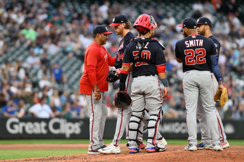 Jun 27, 2023; Seattle, Washington, USA; Washington Nationals manager Dave Martinez (4) pulls starting pitcher Jake Irvin (74) from the game during the sixth inning at T-Mobile Park. Mandatory Credit: Steven Bisig-USA TODAY Sports