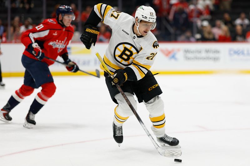 Oct 8, 2025; Washington, District of Columbia, USA; Boston Bruins center Alex Steeves (21) skates with the puck against past Washington Capitals center Aliaksei Protas (21) during the third period at Capital One Arena. Mandatory Credit: Geoff Burke-Imagn Images