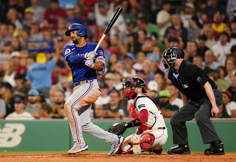 Aug 12, 2024; Boston, Massachusetts, USA; Texas Rangers second baseman Marcus Semien (2) gets a base hit too drive in a run against the Boston Red Sox in the fifth inning at Fenway Park. Mandatory Credit: David Butler II-USA TODAY Sports