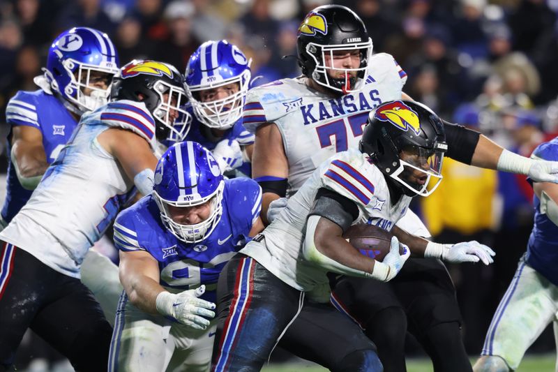 Nov 16, 2024; Provo, Utah, USA; Brigham Young Cougars defensive end Blake Mangelson (93) goes to tackle Kansas Jayhawks running back Devin Neal (4) during the fourth quarter at LaVell Edwards Stadium. Mandatory Credit: Rob Gray-Imagn Images