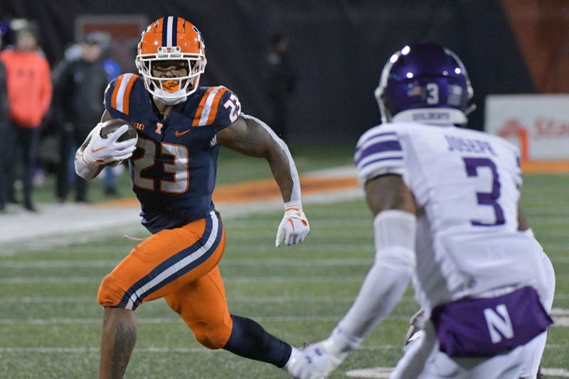 Nov 25, 2023; Champaign, Illinois, USA; Illinois Fighting Illini running back Reggie Love III (23) runs the ball as Northwestern Wildcats defensive back Jaheim Joseph (3) defends during the second half at Memorial Stadium. Mandatory Credit: Ron Johnson-USA TODAY Sports