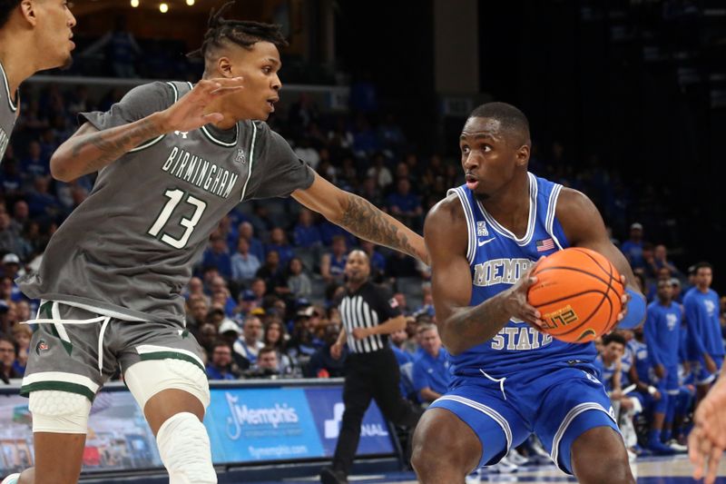 Mar 3, 2024; Memphis, Tennessee, USA; Memphis Tigers forward David Jones (8) drives to the basket as UAB Blazers forward Christian Coleman (13) defends during the first half at FedExForum. Mandatory Credit: Petre Thomas-USA TODAY Sports