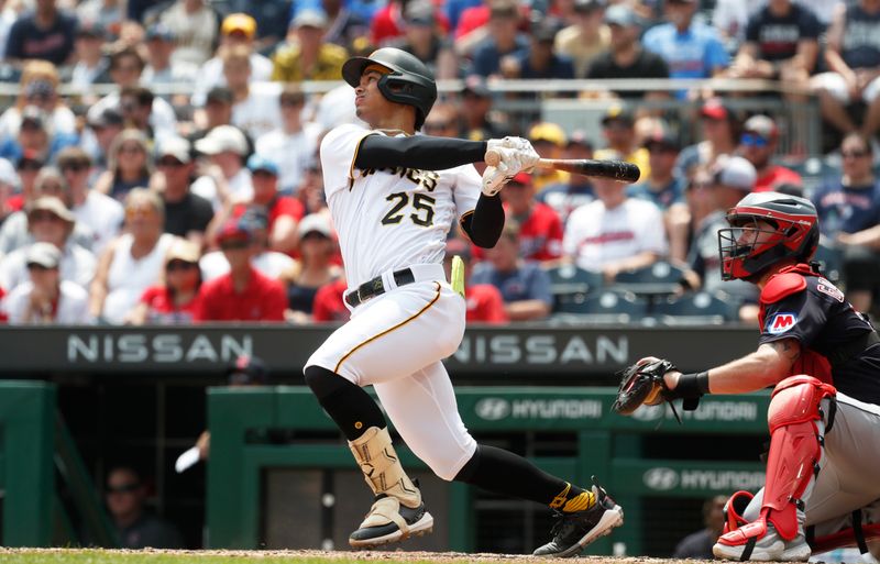 Jul 19, 2023; Pittsburgh, Pennsylvania, USA;  Pittsburgh Pirates catcher Endy Rodriguez (25) hits a single to record the first major league hit of his career against the Cleveland Guardians during the seventh inning at PNC Park. Mandatory Credit: Charles LeClaire-USA TODAY Sports