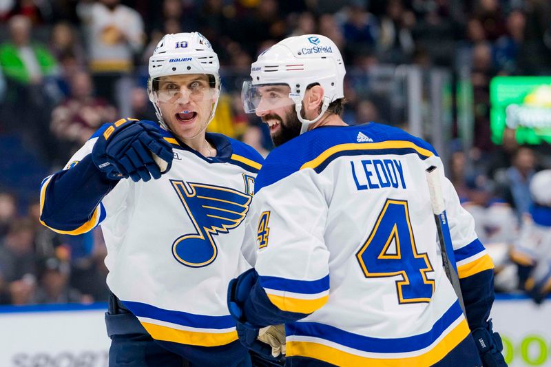 Jan 24, 2024; Vancouver, British Columbia, CAN; St. Louis Blues forward Brayden Schenn (10) and defenseman Nick Leddy (4) celebrate Schenn   s game winning goal against the Vancouver Canucks in overtime at Rogers Arena. Blues 4-3 in overtime. Mandatory Credit: Bob Frid-USA TODAY Sports