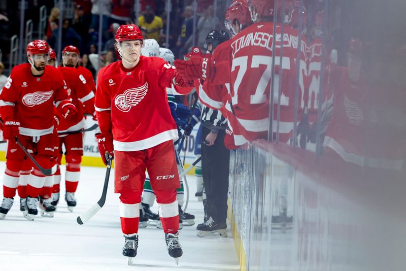 Dec 1, 2024; Detroit, Michigan, USA;  Detroit Red Wings right wing Jonatan Berggren (48) receives congratulations from teammates after scoring in the first period against the Vancouver Canucks at Little Caesars Arena. Mandatory Credit: Rick Osentoski-Imagn Images