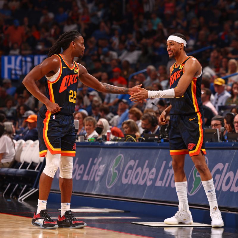 OKLAHOMA CITY, OK - APRIL 14:  Cason Wallace #22 and Aaron Wiggins #21 of the Oklahoma City Thunder high five during the game against the Dallas Mavericks on April 14, 2024 at Paycom Arena in Oklahoma City, Oklahoma. NOTE TO USER: User expressly acknowledges and agrees that, by downloading and or using this photograph, User is consenting to the terms and conditions of the Getty Images License Agreement. Mandatory Copyright Notice: Copyright 2024 NBAE (Photo by Zach Beeker/NBAE via Getty Images)