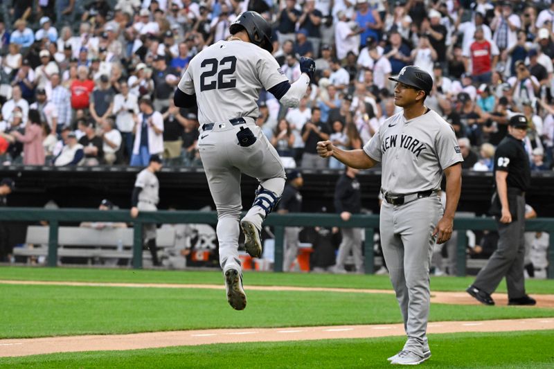 Aug 14, 2024; Chicago, Illinois, USA;  New York Yankees outfielder Juan Soto (22) high fives third base coach Luis Rojas (67) after he hit a home run against the Chicago White Sox during the first inning at Guaranteed Rate Field. Mandatory Credit: Matt Marton-USA TODAY Sports