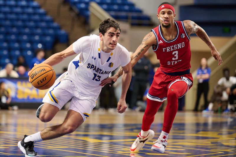 Feb 6, 2024; San Jose, California, USA; San Jose State Spartans guard Alvaro Cardenas (13) dribbles the ball against Fresno State Bulldogs guard Isaiah Hill (3) during the first half at Provident Credit Union Event Center. Mandatory Credit: Robert Edwards-USA TODAY Sports