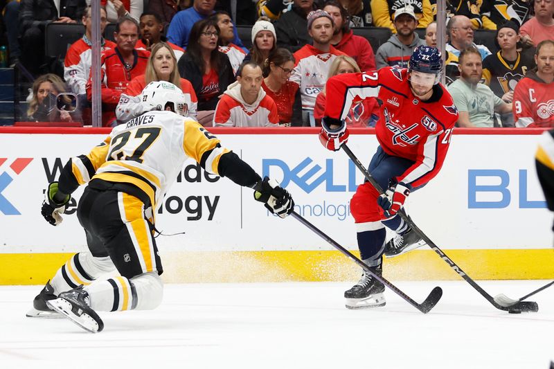 Nov 8, 2024; Washington, District of Columbia, USA; Washington Capitals right wing Brandon Duhaime (22) shoots the puck as Pittsburgh Penguins defenseman Ryan Graves (27) defends in the third period at Capital One Arena. Mandatory Credit: Geoff Burke-Imagn Images