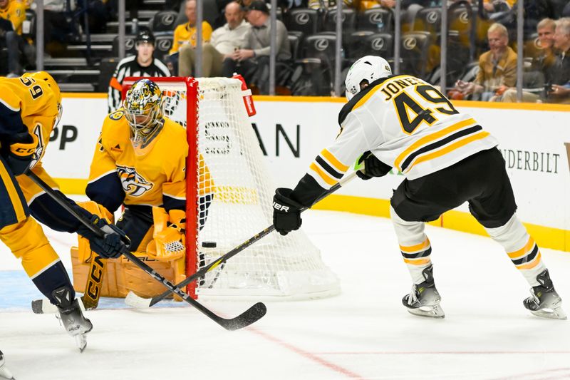 Oct 22, 2024; Nashville, Tennessee, USA; Nashville Predators goaltender Juuse Saros (74) and defenseman Roman Josi (59) block the shot of Boston Bruins left wing Max Jones (49) during the second period at Bridgestone Arena. Mandatory Credit: Steve Roberts-Imagn Images