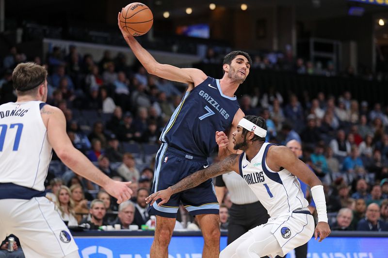 MEMPHIS, TENNESSEE - DECEMBER 11: Santi Aldama #7 of the Memphis Grizzlies looks to pass against Jaden Hardy #1 of the Dallas Mavericks during the second half at FedExForum on December 11, 2023 in Memphis, Tennessee. NOTE TO USER: User expressly acknowledges and agrees that, by downloading and or using this photograph, User is consenting to the terms and conditions of the Getty Images License Agreement.  (Photo by Justin Ford/Getty Images)