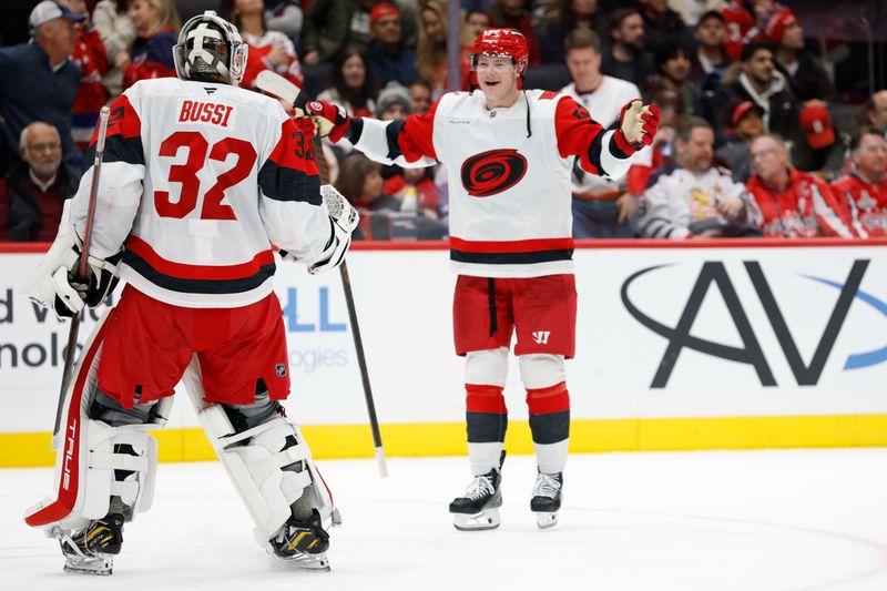 Dec 11, 2025; Washington, District of Columbia, USA; Carolina Hurricanes goaltender Brandon Bussi (32) celebrates with Hurricanes right wing Jackson Blake (53) after their shootout against the Washington Capitals at Capital One Arena. Mandatory Credit: Geoff Burke-Imagn Images