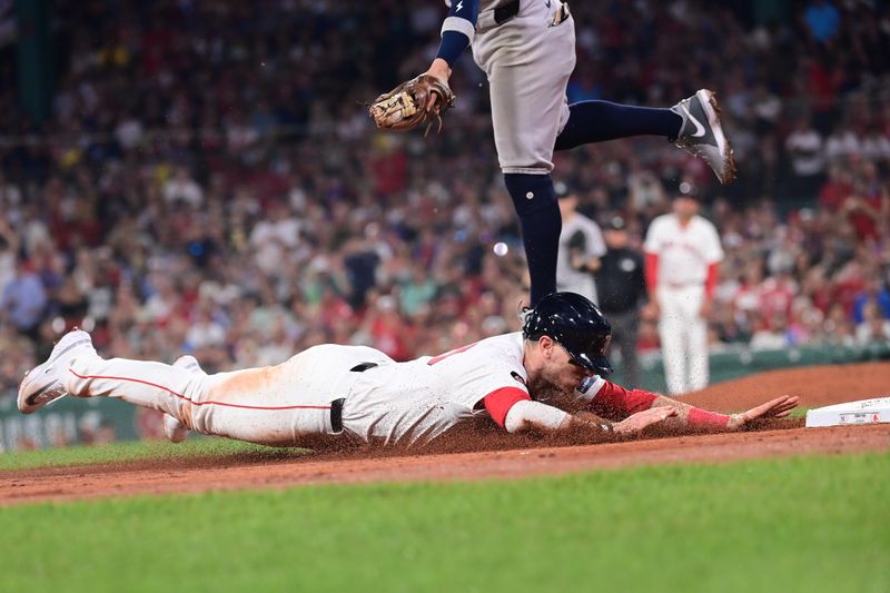 Jul 28, 2024; Boston, Massachusetts, USA; Boston Red Sox designated hitter Danny Jensen (28) dives for third base during the seventh inning against the New York Yankees at Fenway Park. Mandatory Credit: Eric Canha-USA TODAY Sports