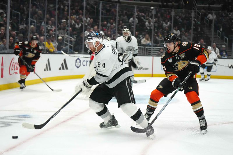 Apr 13, 2024; Los Angeles, California, USA; LA Kings defenseman Vladislav Gavrikov (84) and Anaheim Ducks right wing Troy Terry (19) battle for the puck in the first period at Crypto.com Arena. Mandatory Credit: Kirby Lee-USA TODAY Sports