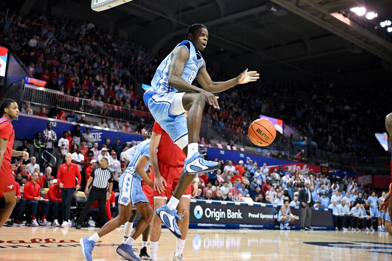 Jan 3, 2026; Dallas, Texas, USA; North Carolina Tar Heels forward Caleb Wilson (8) dunks the ball over SMU Mustangs center Samet Yigitoglu (24) during the first half at Moody Coliseum. Mandatory Credit: Jerome Miron-Imagn Images