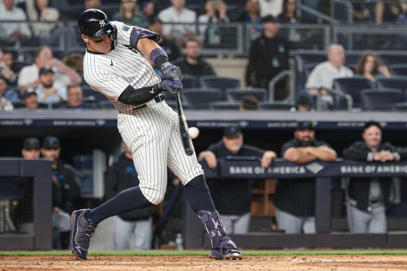 Apr 9, 2024; Bronx, New York, USA; New York Yankees center fielder Aaron Judge (99) doubles during the third inning against the Miami Marlins at Yankee Stadium. Mandatory Credit: Vincent Carchietta-USA TODAY Sports