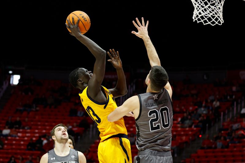 Feb 5, 2023; Salt Lake City, Utah, USA; California Golden Bears forward Kuany Kuany (13) shoots against Utah Utes guard Lazar Stefanovic (20) in the first half at Jon M. Huntsman Center. Mandatory Credit: Jeffrey Swinger-USA TODAY Sports